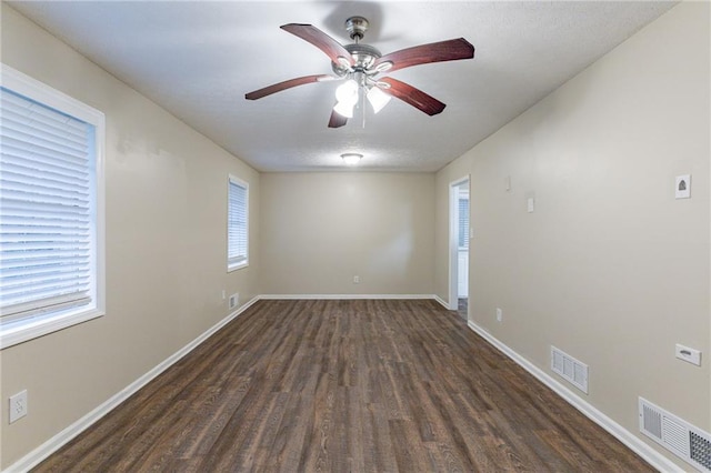 unfurnished room featuring dark hardwood / wood-style floors and ceiling fan