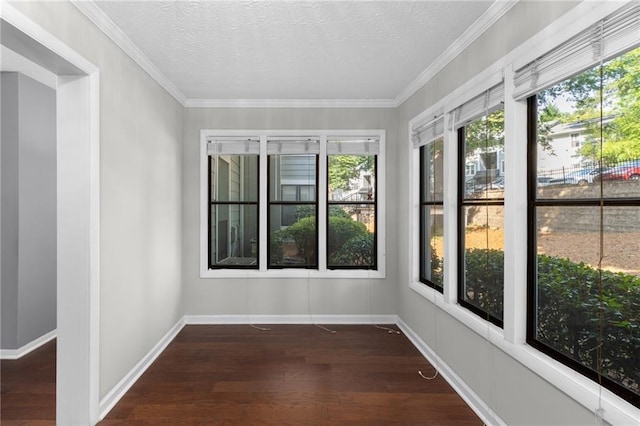603 Summit N Dr NE Unit 603, Atlanta, GA 30324 - unfurnished sunroom with plenty of natural light, wood finished floors, a textured ceiling, baseboards, and crown molding