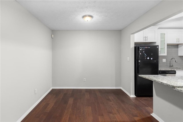 603 Summit N Dr NE Unit 603, Atlanta, GA 30324 - kitchen featuring freestanding refrigerator, glass insert cabinets, a sink, white cabinetry, and tasteful backsplash