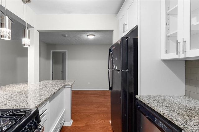603 Summit N Dr NE Unit 603, Atlanta, GA 30324 - kitchen with black appliances, dark wood-style floors, white cabinetry, light stone counters, and baseboards