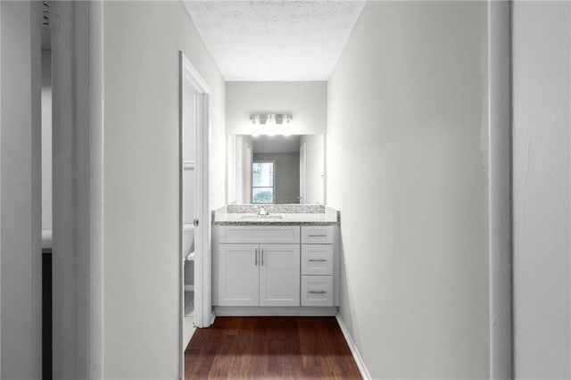603 Summit N Dr NE Unit 603, Atlanta, GA 30324 - bathroom with a textured ceiling, wood finished floors, vanity, and toilet