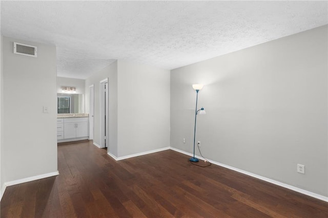 603 Summit N Dr NE Unit 603, Atlanta, GA 30324 - unfurnished room with dark wood finished floors, baseboards, and a textured ceiling