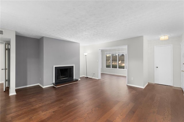 603 Summit N Dr NE Unit 603, Atlanta, GA 30324 - unfurnished living room with wood finished floors, baseboards, a textured ceiling, and a fireplace with raised hearth
