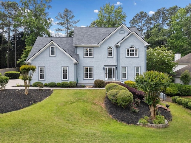 5711 Brynwood Cir NW, Acworth, GA 30101 - view of front of home with a front yard, a shingled roof, and stucco siding