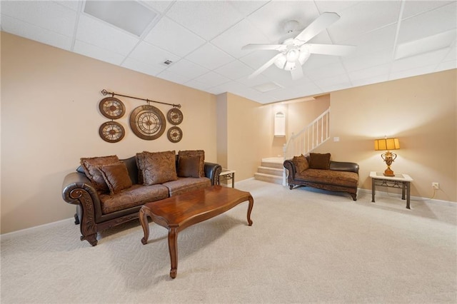 5711 Brynwood Cir NW, Acworth, GA 30101 - living room featuring carpet flooring, a drop ceiling, stairway, a ceiling fan, and baseboards