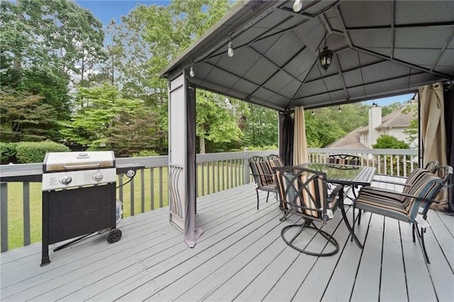 5711 Brynwood Cir NW, Acworth, GA 30101 - deck featuring a gazebo, outdoor dining area, a grill, and view of wooded area