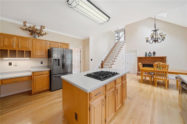 5711 Brynwood Cir NW, Acworth, GA 30101 - kitchen with stainless steel fridge with ice dispenser, black gas cooktop, a chandelier, light wood-type flooring, and ornamental molding