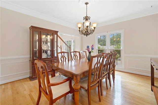 5711 Brynwood Cir NW, Acworth, GA 30101 - dining area with a chandelier, light wood-style floors, crown molding, and wainscoting
