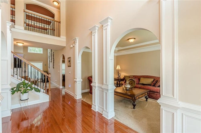 3202 Lucky Pl, Conyers, GA 30013 - foyer entrance featuring hardwood / wood-style floors, a high ceiling, stairs, and arched walkways