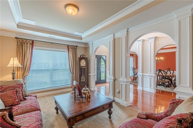 3202 Lucky Pl, Conyers, GA 30013 - living room featuring arched walkways, decorative columns, a tray ceiling, and ornamental molding