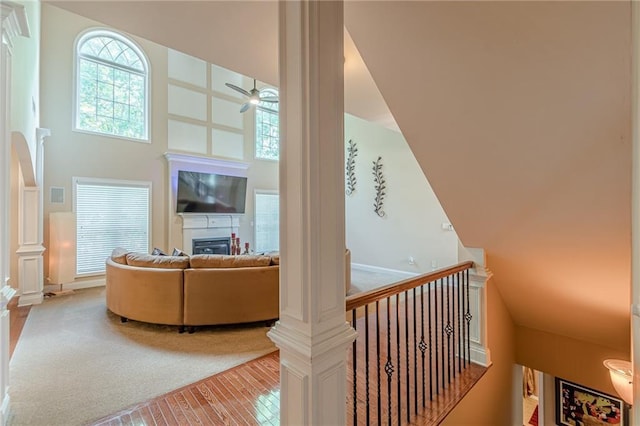 3202 Lucky Pl, Conyers, GA 30013 - living room with hardwood / wood-style flooring, ceiling fan, a glass covered fireplace, and a towering ceiling