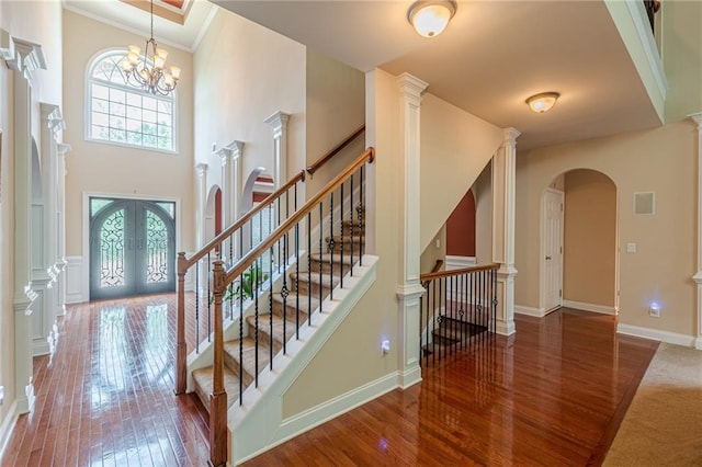 3202 Lucky Pl, Conyers, GA 30013 - entrance foyer featuring french doors, hardwood / wood-style flooring, arched walkways, a high ceiling, and crown molding