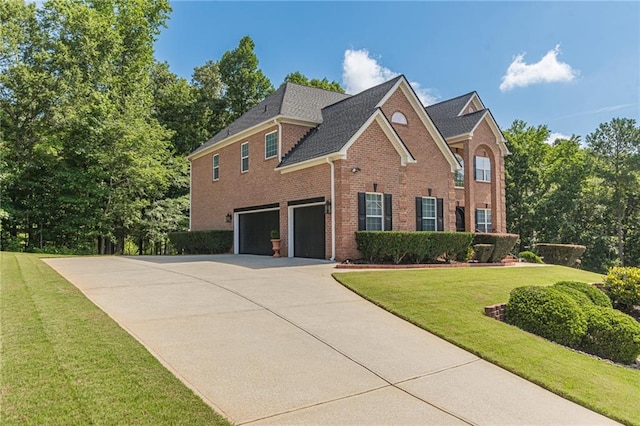 3202 Lucky Pl, Conyers, GA 30013 - view of front facade featuring an attached garage, brick siding, driveway, and a front lawn