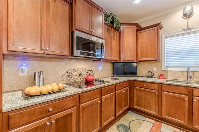 3202 Lucky Pl, Conyers, GA 30013 - kitchen with stainless steel microwave, black electric cooktop, backsplash, light stone counters, and ornamental molding