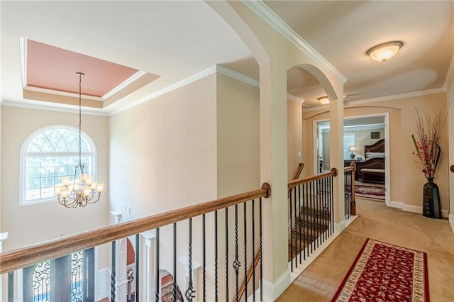3202 Lucky Pl, Conyers, GA 30013 - corridor with a chandelier, carpet flooring, an upstairs landing, arched walkways, and crown molding