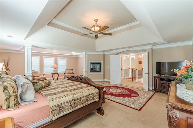 3202 Lucky Pl, Conyers, GA 30013 - carpeted bedroom featuring ornate columns, a raised ceiling, ornamental molding, ceiling fan, and connected bathroom