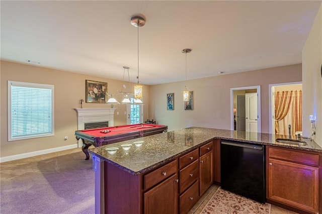 3202 Lucky Pl, Conyers, GA 30013 - kitchen featuring black dishwasher, a fireplace, open floor plan, dark stone countertops, and decorative light fixtures