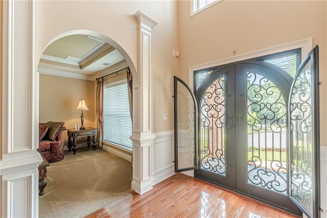 3202 Lucky Pl, Conyers, GA 30013 - entryway with french doors, arched walkways, ornamental molding, and light wood finished floors