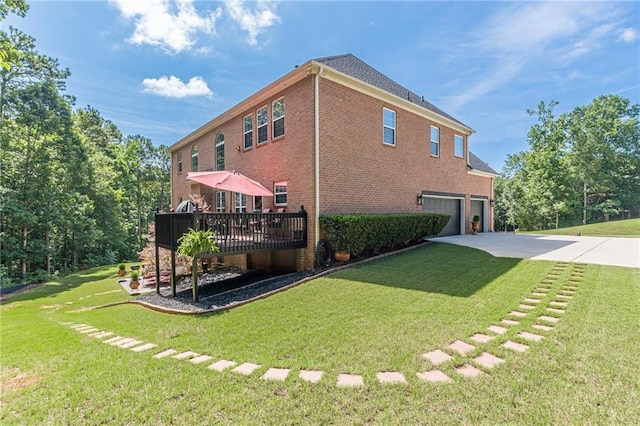 3202 Lucky Pl, Conyers, GA 30013 - back of house featuring an attached garage, brick siding, concrete driveway, a deck, and a lawn