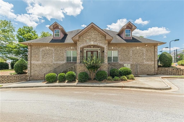 3202 Lucky Pl, Conyers, GA 30013 - french provincial home featuring brick siding, stairway, and french doors