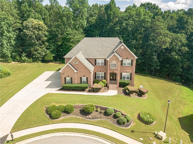 3202 Lucky Pl, Conyers, GA 30013 - colonial-style house featuring driveway, brick siding, and a front lawn