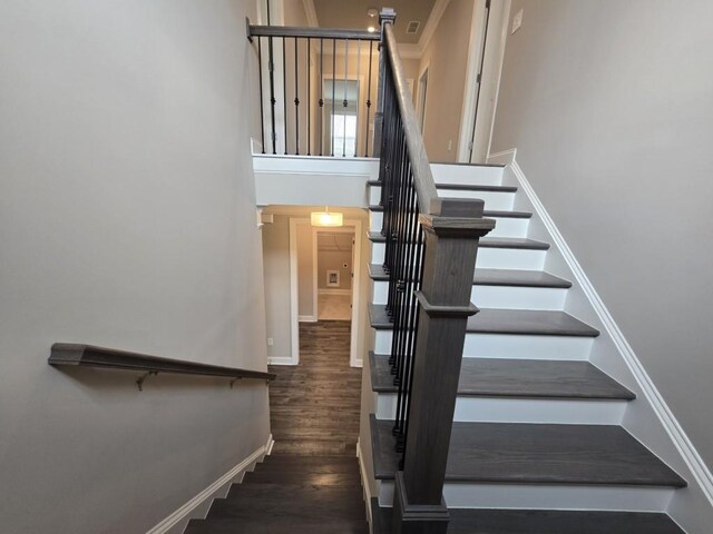 staircase with hardwood / wood-style floors