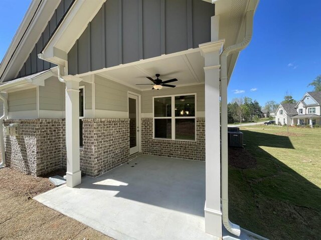 back of property featuring a lawn and central air condition unit