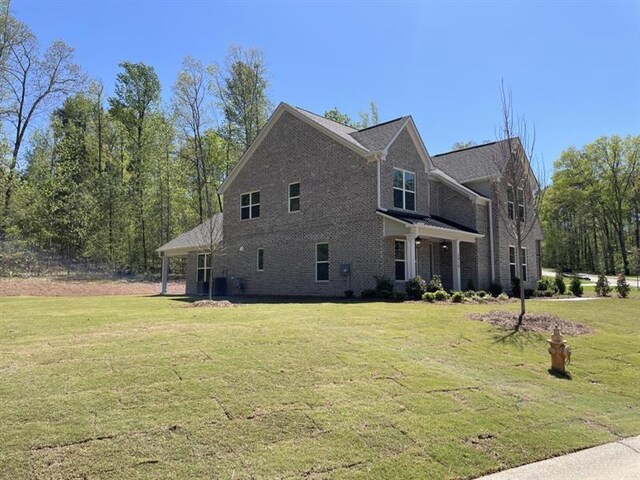 rear view of property with cooling unit, a yard, and a patio area