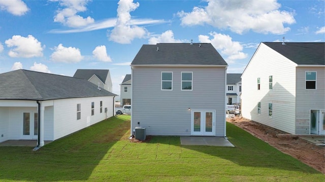 rear view of property featuring a patio, french doors, central AC unit, and a yard