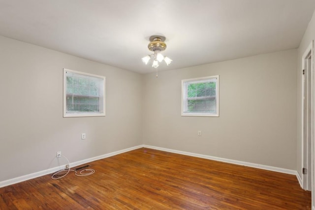 unfurnished room featuring baseboards, ceiling fan, and wood finished floors
