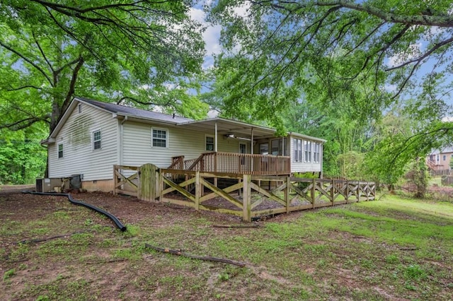 rear view of house with a sunroom, crawl space, a ceiling fan, and a wooden deck