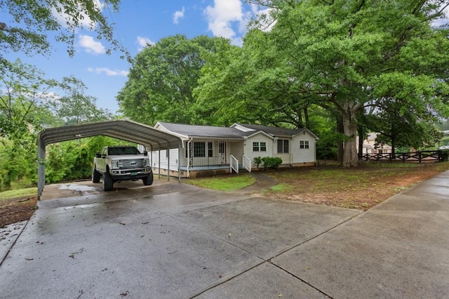 view of front of home featuring a detached carport and driveway