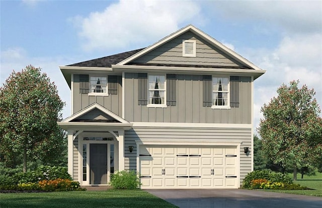 view of front of home with a garage and a front yard