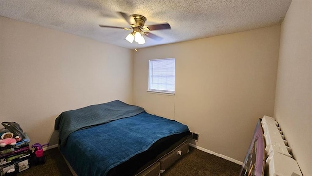 carpeted bedroom with ceiling fan and a textured ceiling