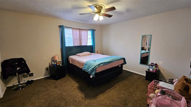 bedroom with a textured ceiling, ceiling fan, and dark colored carpet