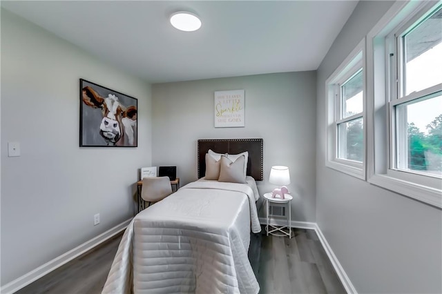 bedroom featuring baseboards and wood finished floors