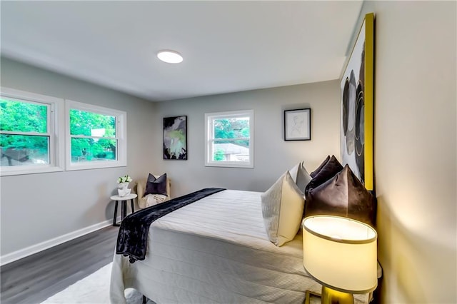 bedroom with baseboards and dark wood-style floors