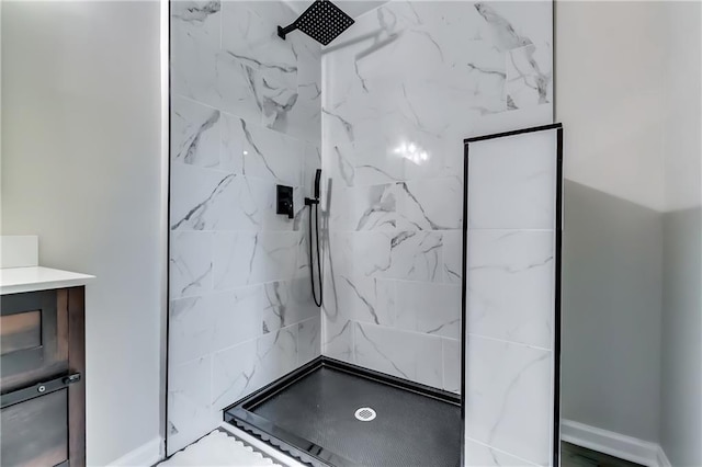 bathroom with a marble finish shower