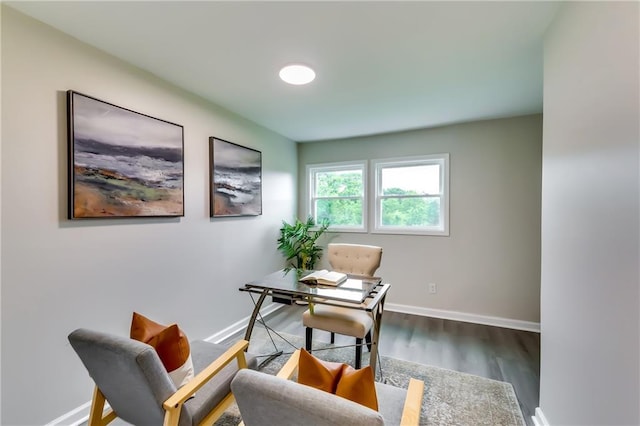 home office with baseboards and wood finished floors