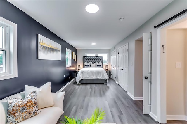 bedroom featuring baseboards, recessed lighting, and wood finished floors