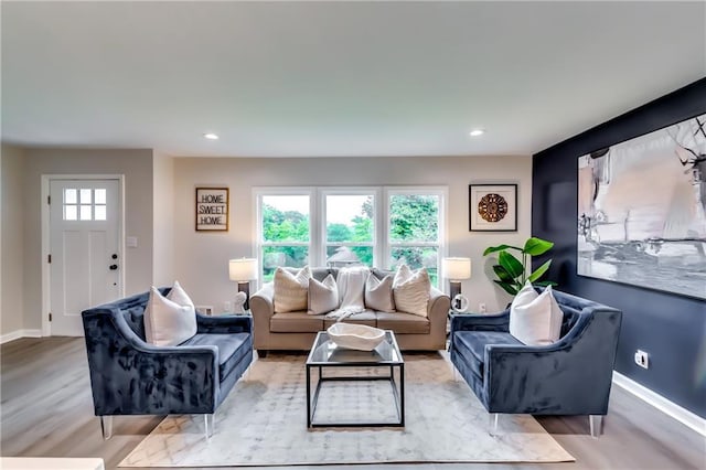 living room featuring recessed lighting, baseboards, and light wood-style floors