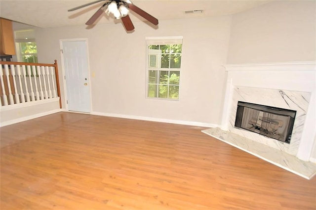 2172 Cold Springs Cir, Lithonia, GA 30058 - unfurnished living room with wood finished floors, a ceiling fan, and a high end fireplace