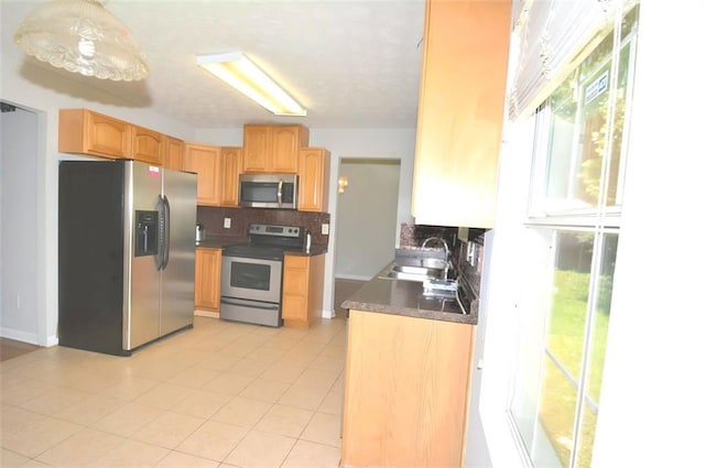 2172 Cold Springs Cir, Lithonia, GA 30058 - kitchen with appliances with stainless steel finishes, tasteful backsplash, dark countertops, light tile patterned flooring, and light brown cabinets