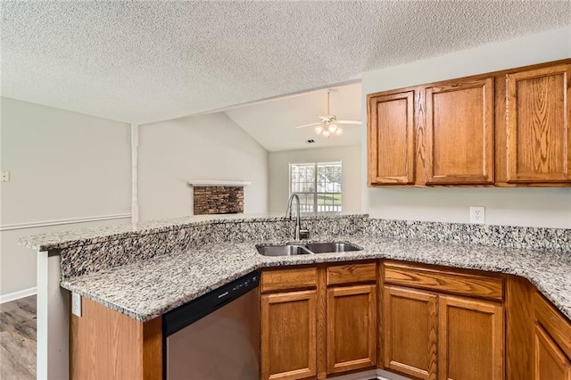230 Belmont Trl, Covington, GA 30016 - kitchen featuring stainless steel dishwasher, a peninsula, brown cabinetry, a textured ceiling, and vaulted ceiling