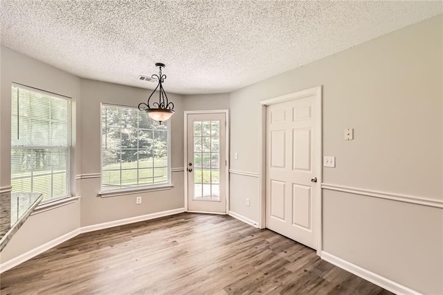 230 Belmont Trl, Covington, GA 30016 - unfurnished dining area featuring wood finished floors and a textured ceiling