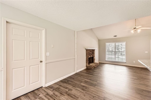 230 Belmont Trl, Covington, GA 30016 - unfurnished living room featuring wood finished floors, a stone fireplace, a ceiling fan, and lofted ceiling