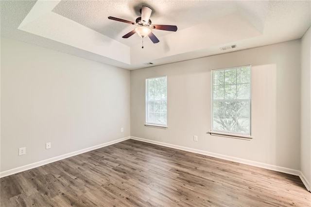230 Belmont Trl, Covington, GA 30016 - empty room featuring a raised ceiling, ceiling fan, wood finished floors, and a textured ceiling