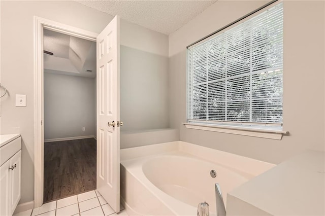230 Belmont Trl, Covington, GA 30016 - full bathroom featuring vanity, a bath, a textured ceiling, and tile patterned flooring