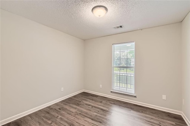 230 Belmont Trl, Covington, GA 30016 - unfurnished room with dark wood finished floors and a textured ceiling