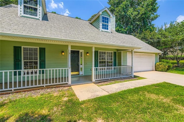 230 Belmont Trl, Covington, GA 30016 - new england style home featuring covered porch, roof with shingles, a front lawn, driveway, and an attached garage